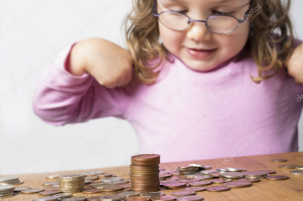 Smiling girl counting money for savings