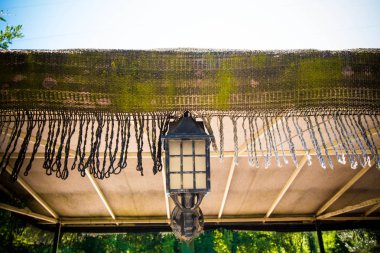 Binanın çatısında vintage fener. Mavi ve berrak gökyüzüne karşı fener ve çatı.