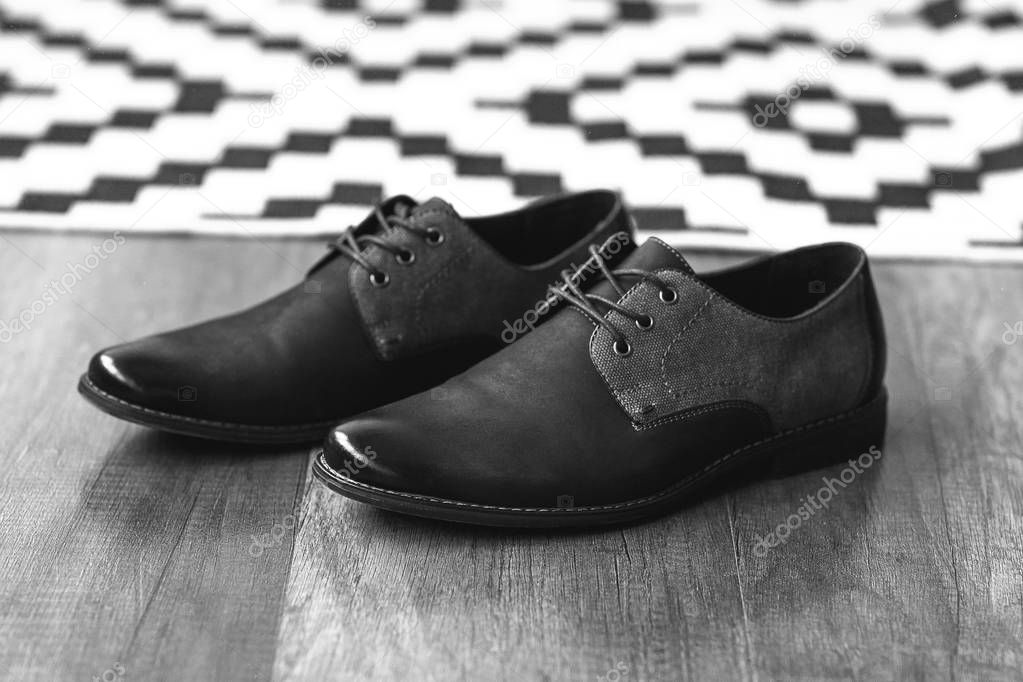 Men's dark blue shoes on wooden floor. Fahion still-life boots.