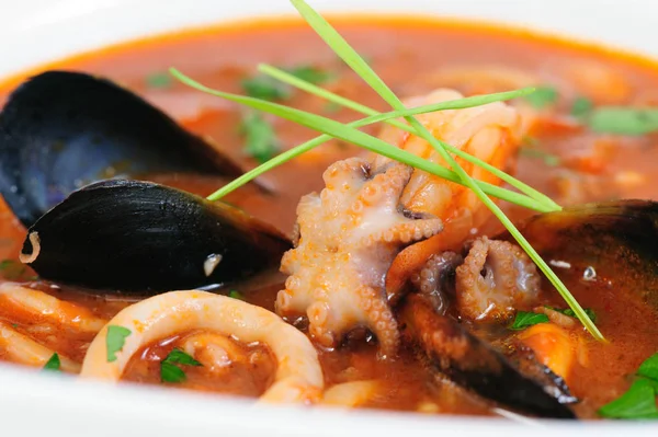 Sopa de frutos do mar em prato branco close-up — Fotografia de Stock