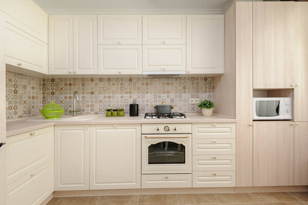 Modern beige colored kitchen and dining room