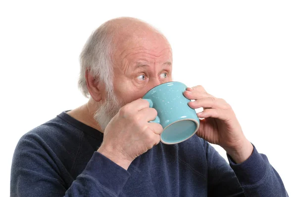 Elderly man with cup of tea or coffee isolated on white — Stock Photo, Image