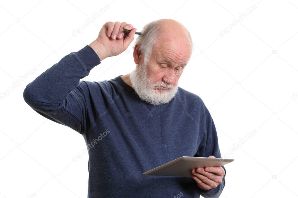 Funny old man using tablet computer and puzzled, isolated on white