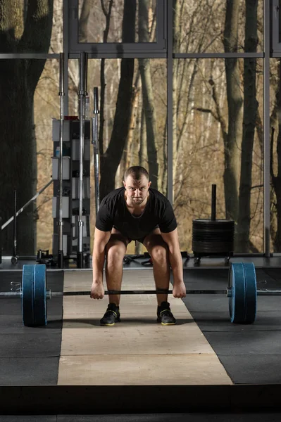 Deadlift attempt. Young man trying to lift heavy barbell — Stock Photo, Image