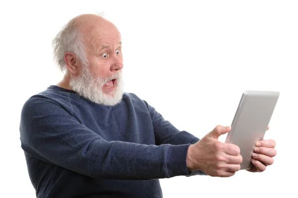 Funny shocked senior man using tablet computer isolated on white — Stock Photo, Image