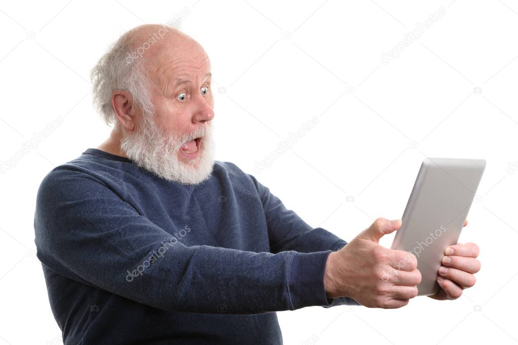Funny shocked senior man using tablet computer isolated on white