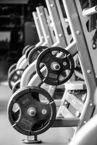 Modern gym interior with bench press equipment in a raw — Stock Photo, Image