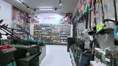 Çoğu Bosch markasından olmak üzere çeşitli elektrikli aletlerle bir DIY dükkanındaki rafların panoraması.
