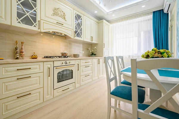 Beige, white and cyan furniture at kitchen in provence style,
