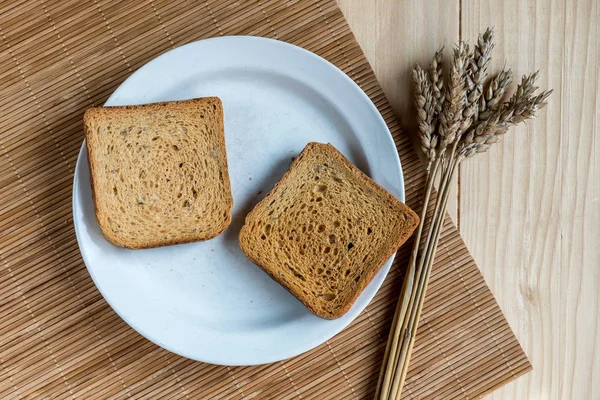 Dos Rebanadas Pan Tostado Oreja Trigo Una Mesa Madera —  Fotos de Stock