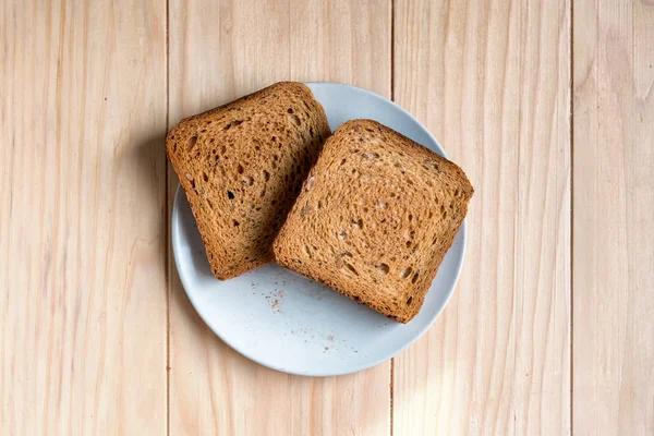 Dos Rebanadas Pan Tostado Una Mesa Madera —  Fotos de Stock