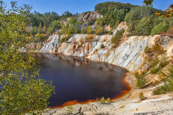 Black artificial lake and hills — Stock Photo, Image