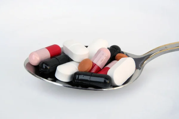 Medication as a food. Healthy nutrition. Medical pills in a spoon.