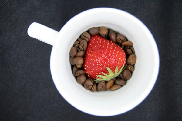 Strawberry on coffee beans. Strawberry and coffee.