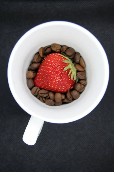 Strawberry on coffee beans. Strawberry and coffee.