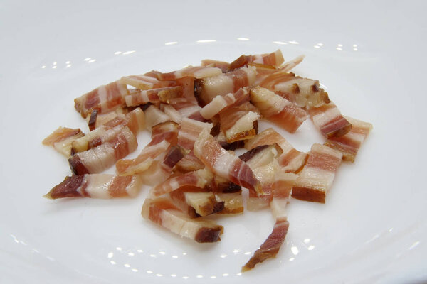 Small bacon slices. Smoked bacon slices.