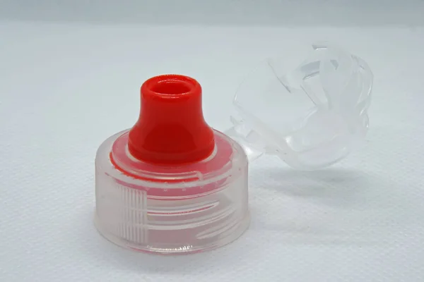 Plastic bottle cap. Red and white plastic bottle cap.