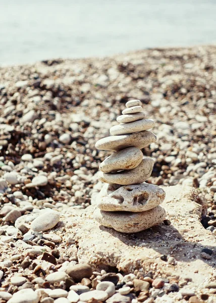 a stack of pebbly Zen stones on the sea beach