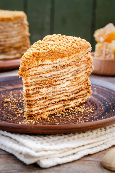 Traditional Honey Cake on a plate and on a wooden table