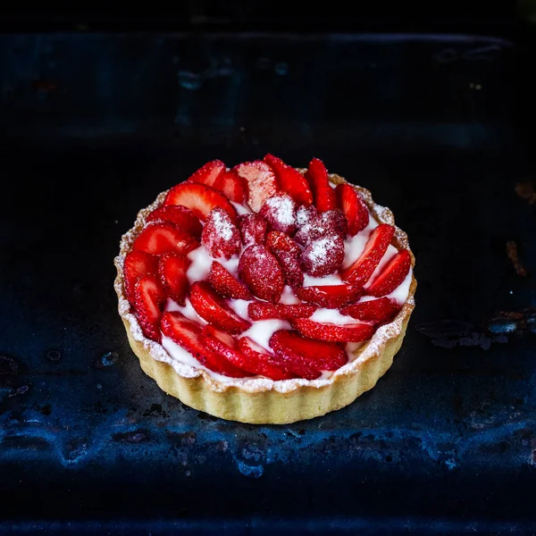 Strawberry shortcake pies (Strawberries tartlet) on black background, perfect party individual fresh fruit dessert. Square.