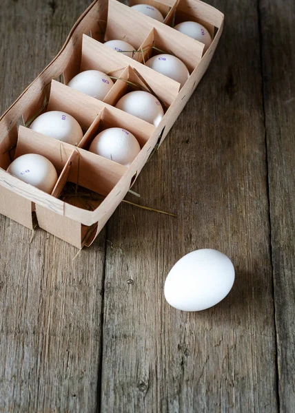 eggs in wooden box on old wooden background