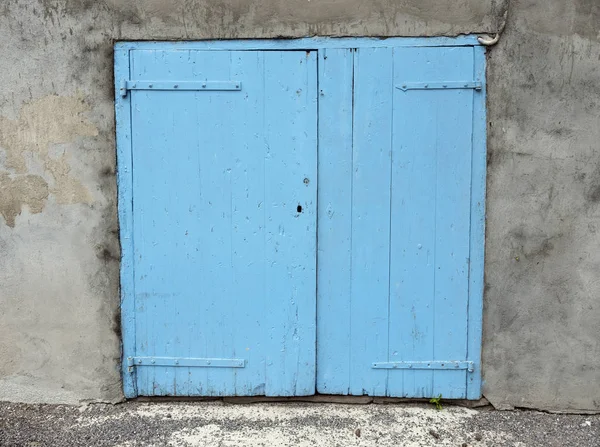 Old blue doors shutters in wall of house in french provence — Stock Photo, Image