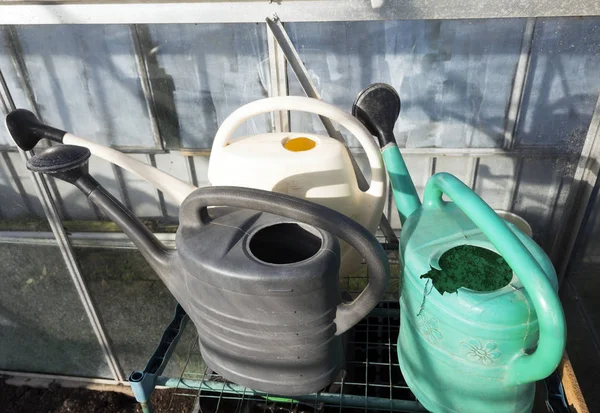Green Grey White Watering Cans Greenhouse Blue Sky Lit Sun — Stock Photo, Image