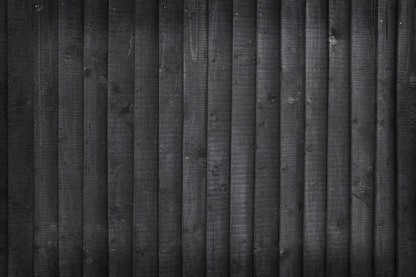Hintergrund bestehend aus schwarz gebeizten Holzbohlen auf Zäunen — Stockfoto