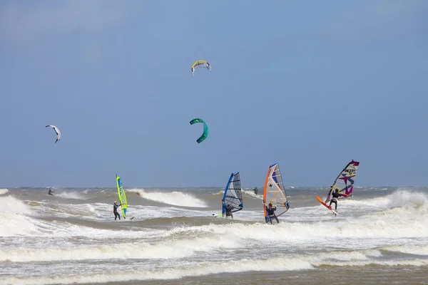 Wind and kite surfing on high waves during summer storm on north — Stock Photo, Image