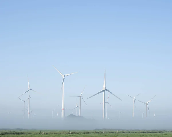 Wind turbines in green meadow near aurich in ostfriesland on mis — Stock Photo, Image