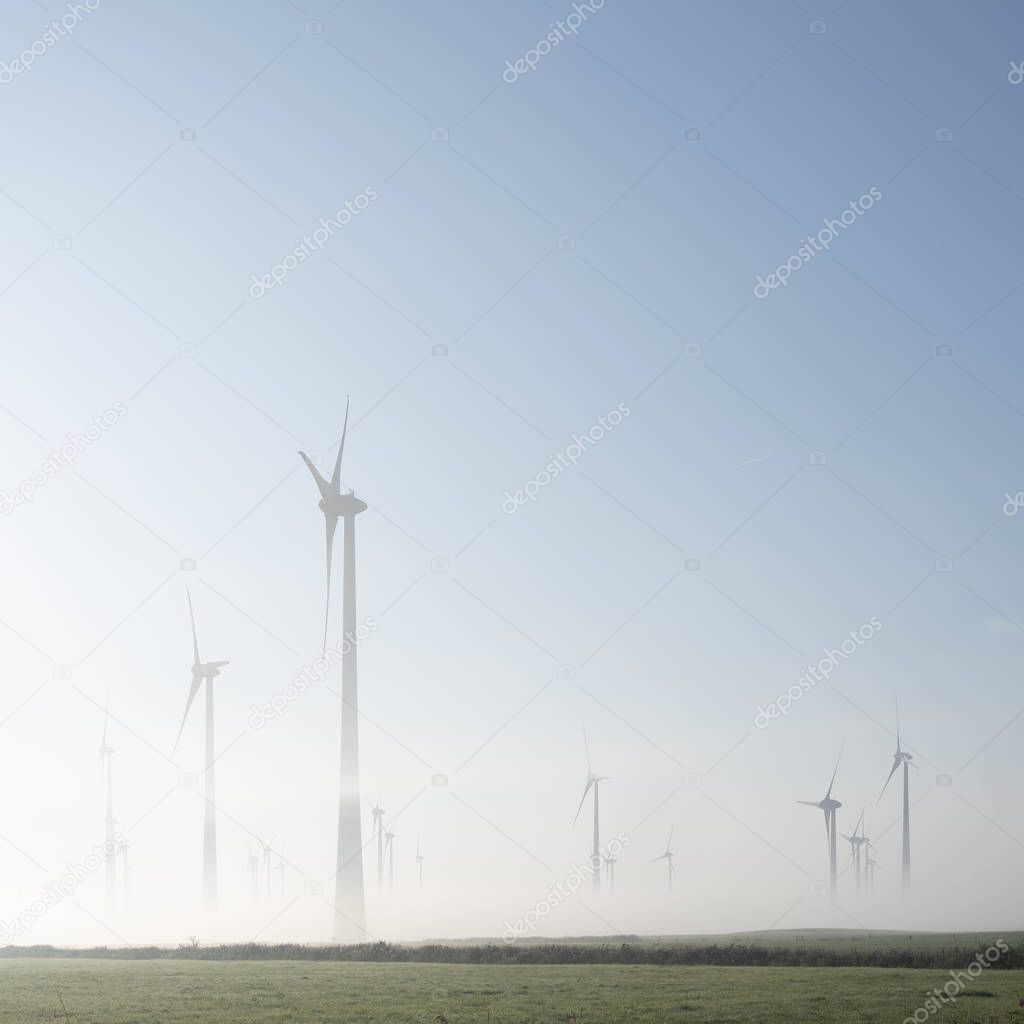 wind turbines in green meadow near aurich in ostfriesland on mis