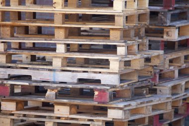closeup of pile of empty wooden pallets