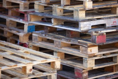 closeup of pile of empty wooden pallets