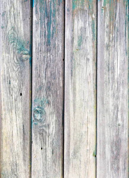 Old grunge planks of door to woodshed with remains of old colored paint — Stock Photo, Image