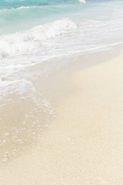 Sandy beach with foamy water