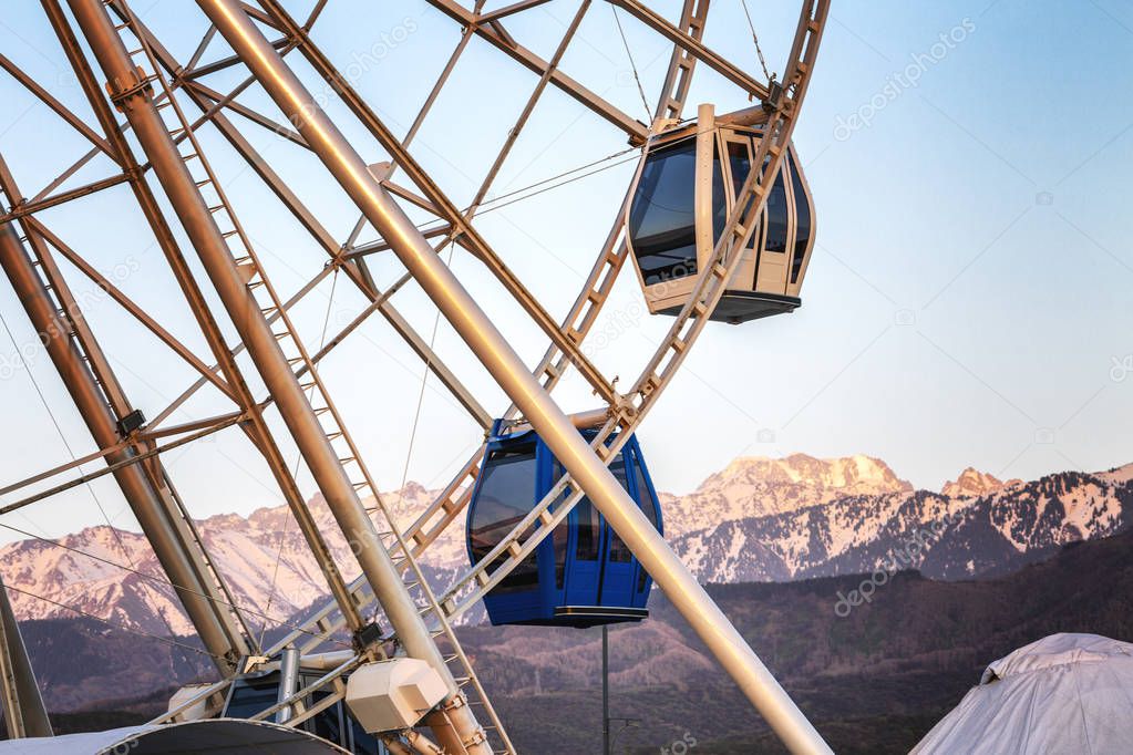Ferris wheel on a background of mountains, close-up