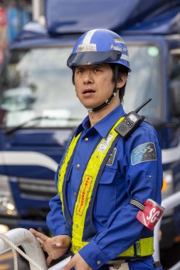 Japonya, Tokyo, 04/12/2017. Üniformalı bir şehir sokakta yol işçisi