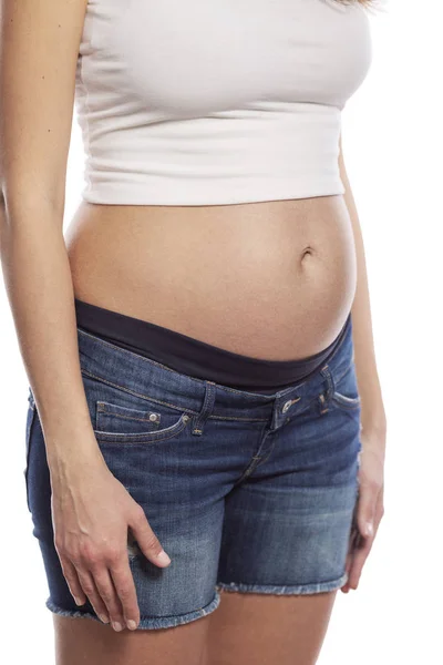 Pregnant young woman. Early term. Isolated on a white background — Stock Photo, Image