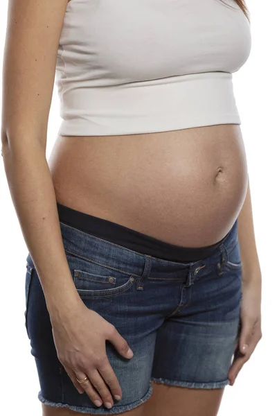 Belly of a pregnant woman. Term 6 months, close-up. Isolated on white background — Stock Photo, Image