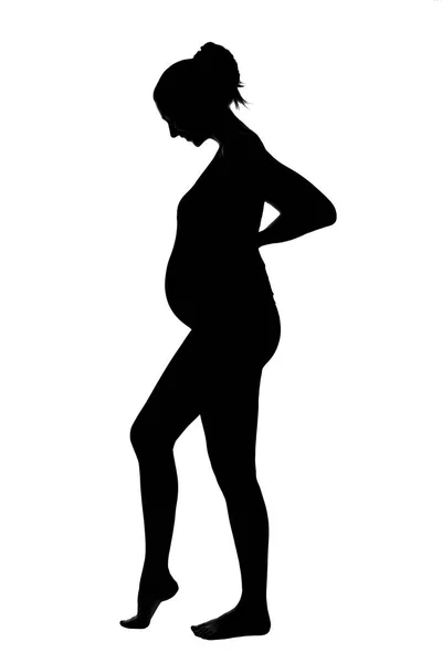 Silhouette de una mujer embarazada de larga duración. — Foto de Stock
