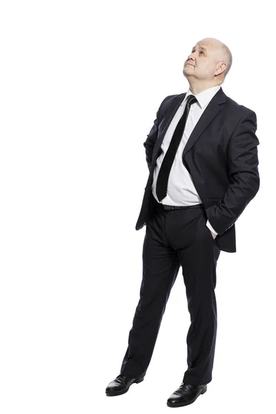 Bald middle-aged man in a suit in full growth looks up. Isolated on a white background. — Stock Photo, Image