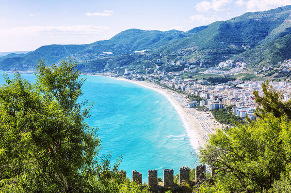 The fortress wall on the background of bright blue sea on a sunny day. Beautiful landscape. Space for text.
