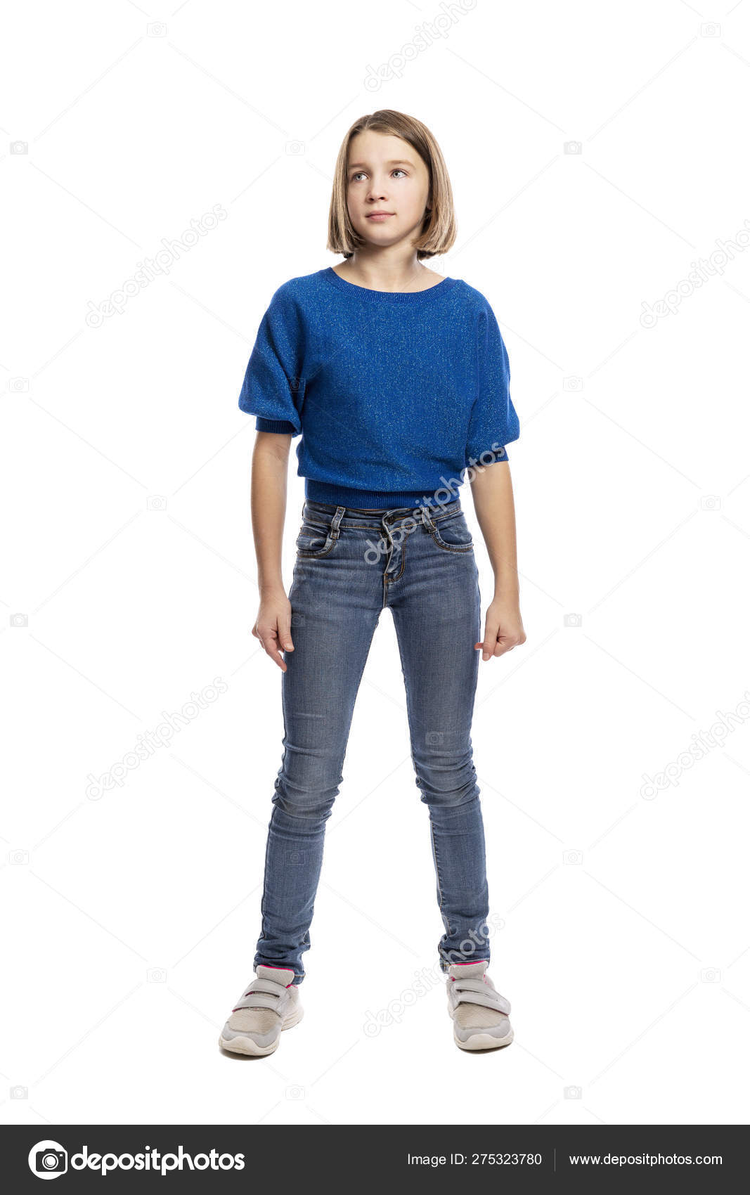 Cute teen girl in blue sweater and jeans standing, full length. Isolated on  a white background. Stock Photo by ©Demanna 275323780