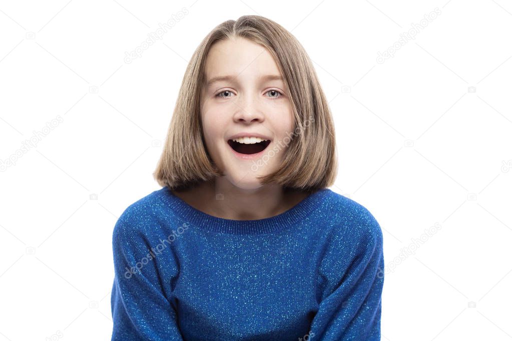 Cute teen girl in a blue sweater laughs. Close-up. Isolated on a white background.