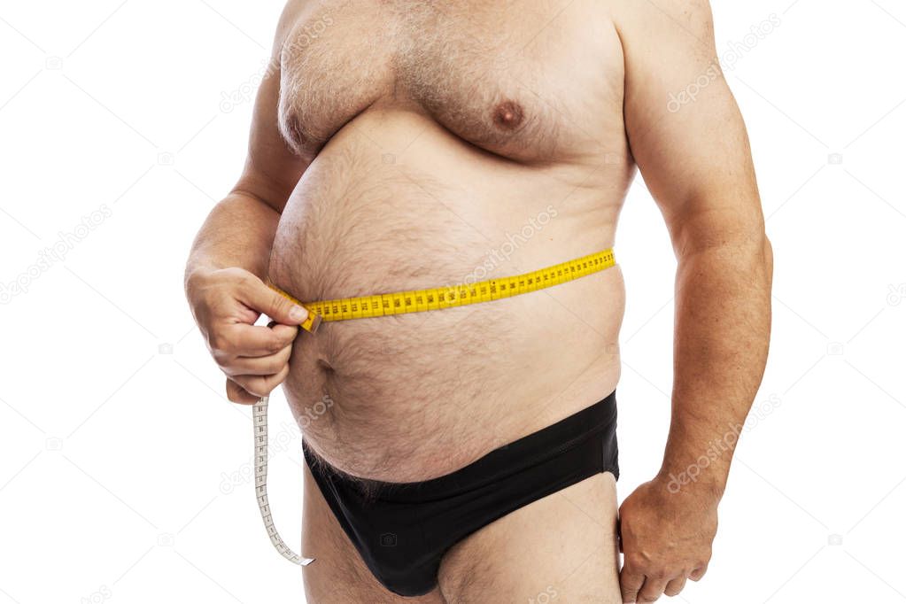 Fat man measures the abdominal circumference. Isolated on a white background.