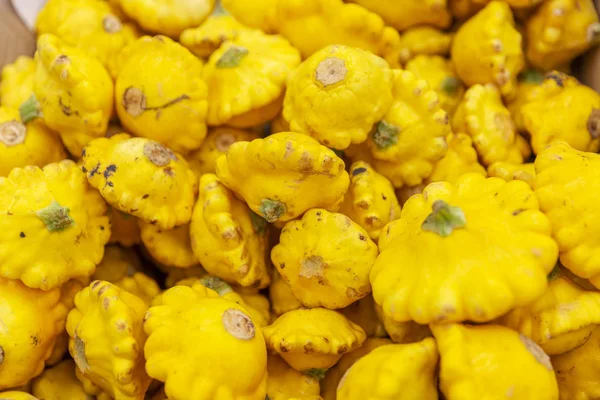 Yellow squash in a box in a supermarket. Close-up. Background. Space for text.