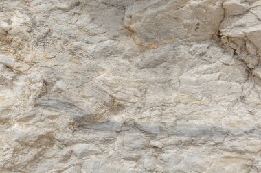Doğal taş yüzeyinin dokusu, yakın çekim. Antik medeniyetlerin yapı malzemesi. Arka plan. Metin boşlukları.