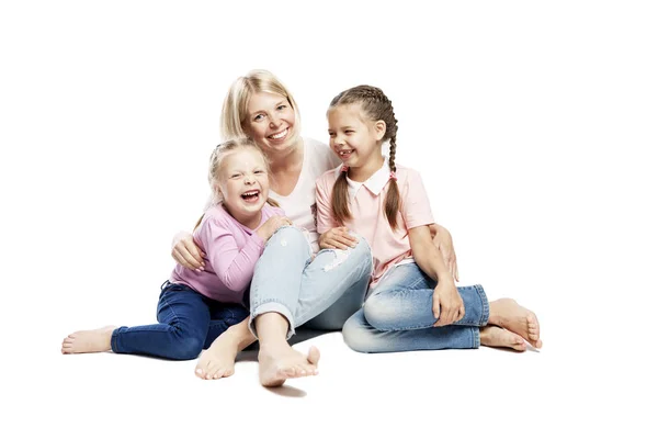 Mom and daughters are sitting and laughing. Love and tenderness. Isolated on a white background. — Stock Photo, Image