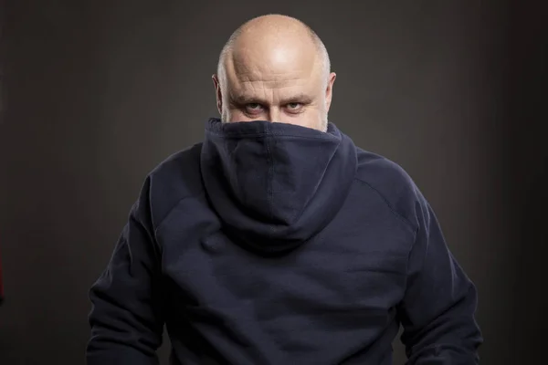 Smiling bald man in a hoodie. Humor. Black background. — Stock Photo, Image
