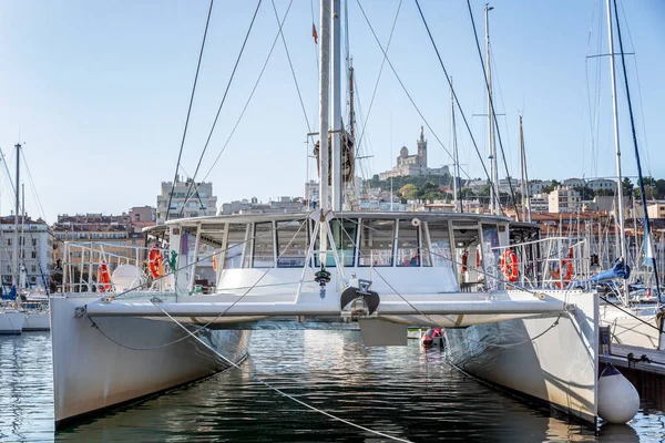 Large sailing catamaran in a marina in Marseille. Tourism and travel. Sunny day. Beautiful landscape.